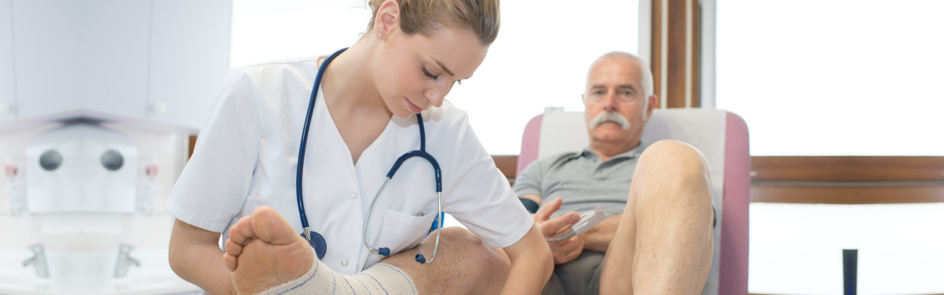 Doctor Bandaging elderly foot