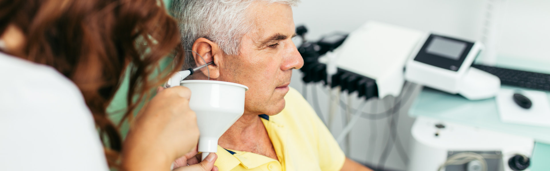 Doctor removing object from the ear